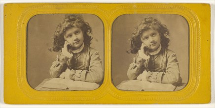 Little girl seated with hand on cheek, open book in front of her; 1855 - 1860; Hand-colored Albumen silver print