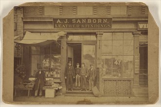 Five men posing in front of establishment of A.J. Sanborn, Leather & Findings; American; about 1875; Albumen silver print