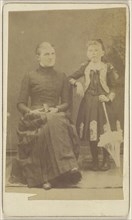 Mother sitting with a book in her lap, girl standing with an umbrella; American; about 1870; Albumen silver print
