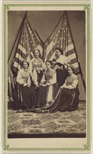 Five women, two standing, three seated, in costume, posed in front of two American flags; American; about 1865; Albumen silver