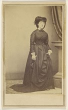 woman wearing a hat and long dark dress; Attributed to Mathew B. Brady, American, about 1823 - 1896, about 1868; Albumen silver