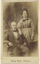 couple: bearded man, seated and woman, standing; E.B. Perry Brothers; 1860s; Albumen silver print