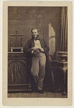 man with muttonchops, standing, holding a newspaper; Camille Silvy, French, 1834 - 1910, 1860s; Albumen silver print