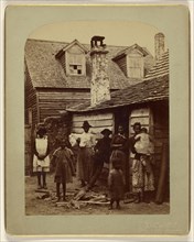 Black family grouping of eight posed at house entrance; George Barker, American, 1844 - 1894, 1886; Albumen silver print
