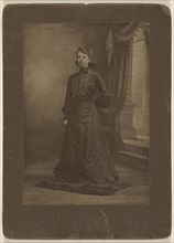 Portrait of a young woman in long black dress, standing; George W. Killian, American, 1876 - 1938, about 1900; Gelatin silver