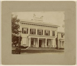 View of a large white house with pillars; about 1890; Gelatin silver print