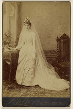 woman in wedding gown, standing; Walker; 1870s; Albumen silver print