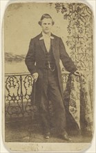 well-dressed man holding a walking stick; about 1868; Albumen silver print