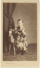 little boy standing with toy pony; A. Duval, French, active 1880s, about 1865; Albumen silver print