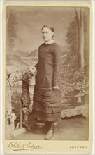 young girl holding a basket, standing; Blake & Edgar; about 1885; Gelatin silver print