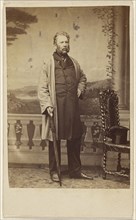 bearded man, holding an umbrella, standing; John Urie, Scottish, 1820 - 1910, active Glasgow, Scotland, 1862 - 1865; Albumen