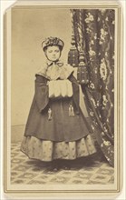 little girl dressed in winter clothing with hand muff, standing; Emery R. Gard, American, active 1856 - 1866, 1865 - 1870