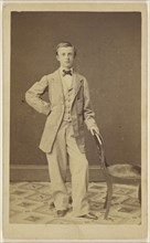 well-dressed young man wearing a bowtie, standing; 1861; Albumen silver print