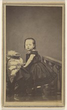 little girl standing, leaning on a prop in a studio; S. Bruckner; 1865 - 1870; Albumen silver print