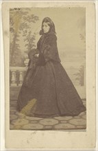 woman wearing a long dress with veil and muff, standing; George Daniels Morse, American, active San Francisco, California