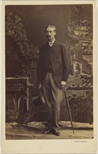 man with moustache, holding a top hat and umbrella, standing; Southwell Brothers, English, 1862 - 1878, 1863 - 1864; Albumen