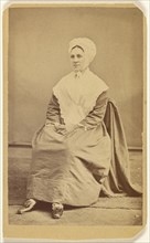 woman wearing a bonnet and shawl, seated; F. James Evans, American, born 1833, active York, Pennsylvania, 1865 - 1870; Albumen