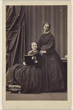 E.J.B. two  women: one seated, holding a book; one standing; Camille Silvy, French, 1834 - 1910, about 1866; Albumen silver