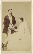 wedding couple: groom standing, bride seated; Hills & Saunders, British, active about 1860 - 1920s, 1865-1870; Albumen silver