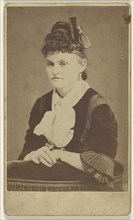 woman seated, leaning on chair arm; T.M. Saurman, American, 1846 - 1908, active Norristown, Pennsylvania, 1870 - 1875; Albumen