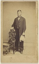 man with long muttonchops, standing, holding a white hat; Charles E. Crouse, American, active 1870s, 1870-1875; Albumen silver