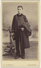 well-dressed young boy standing, holding his cap in his right hand, his coat over his left arm; A. Clément, French, active 1860s