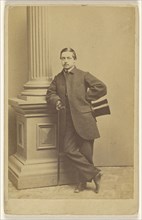 man with moustache standing, holding a top hat in one hand, a cane in the other; Beniczky & Co; 1865 - 1870; Albumen silver