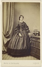 woman wearing a long dress, standing; Maull & Polyblank, British, active 1850s - 1860s, 1862 - 1865; Albumen silver print