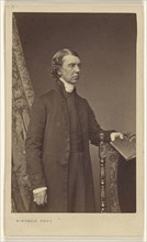 man standing, holding a book over a chair back; Robert Jefferson Bingham, British, 1824 - 1870, 1865 - 1870; Albumen silver