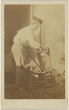 Man in a round cap, repairing a chair; 1870 - 1875; Albumen silver print