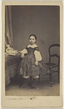 little girl standing, with elbow on table; C. Robert, French, active Senlis, France 1860s, 1865 - 1875; Albumen silver print