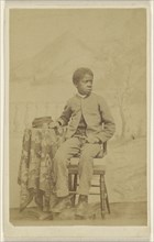 African-American boy in uniform, seated in 3,4 profile; 1870-1875; Albumen silver print