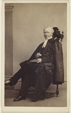 elderly man seated with a book in his lap, finger holding its place; Thomas Rodger, Scottish, 1832 - 1883, 1864 - 1865; Albumen
