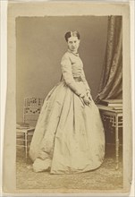 woman wearing a long dress, standing; 1865 - 1870; Albumen silver print