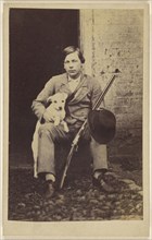 Man seated with a white dog, a rifle and hat leaning on his leg; 1865 - 1875; Albumen silver print