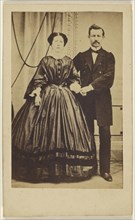 couple: man with moustache and woman with her hair parted in the middle, both standing; Photographische Compagnie; 1865 - 1875