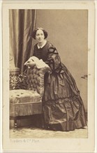 woman standing, leaning over the back of a chair; Disdéri & Cie; 1862 - 1864; Albumen silver print
