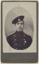 military man with moustache wearing a cap, a pin on his lapel; 1880 - 1885; Albumen silver print