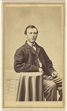 man seated, with arm on small covered table; Frank Forshew, American, 1827 - 1895, 1865-1875; Albumen silver print