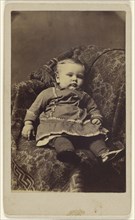 child seated in a large upholstered chair; Louis Hess, American, active Cobleskill, New York 1860s, 1870-1880; Albumen silver