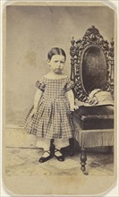 little girl standing near an ornate chair; 1870 - 1880; Albumen silver print