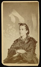 woman seated with arms of a  spirit  over her head; William H. Mumler, American, 1832 - 1884, Boston, Massachusetts, United