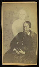 elderly woman seated, three  spirits  in the background; William H. Mumler, American, 1832 - 1884, Boston, Massachusetts