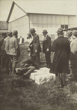 Men standing around white boxes on the ground; Fédèle Azari, Italian, 1895 - 1930, Italy; 1914 - 1929; Gelatin silver print