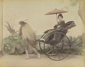 Woman with Parasol Posed Being Pulled in a Jinrikisha by a Man Wearing a Straw Rain Coat; Attributed to Kusakabe Kimbei
