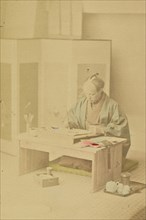 A Japanese Artist at Work; Kazumasa Ogawa, Japanese, 1860 - 1929, 1897; Hand-colored Albumen silver print