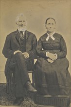 Portrait of a seated couple; American; about 1850 - 1860; Hand-colored salted paper print; 21.3 × 14.6 cm, 8 3,8 × 5 3,4 in