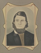 Portrait of a young man with a beard; American; about 1850 - 1860; Hand-colored salted paper print; 19.8 × 14.9 cm