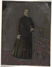 Portrait of standing woman; United States; 1860s - 1880s; Hand-colored tintype; Sheet: 21.2 x 16.3 cm, 8 3,8 x 6 7,16 in