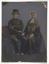 Portrait of seated couple; United States; 1860s - 1880s; Hand-colored tintype; Sheet: 19.9 x 15 cm, 7 13,16 x 5 7,8 in